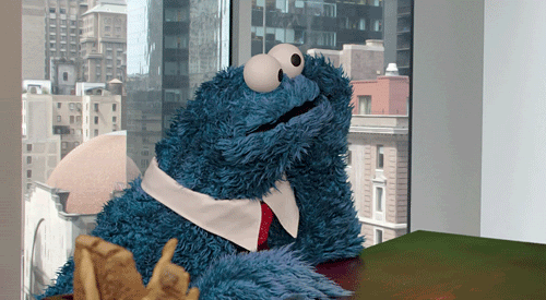 Sesame Street™ Cookie Monster™ drumming his fingers looking bored